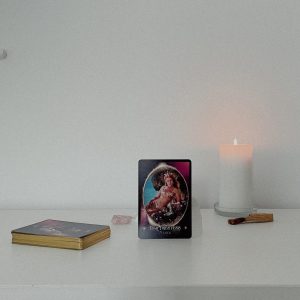 The Priestess Codes Oracle Card Deck with candle lit in background