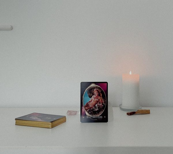 The Priestess Codes Oracle Card Deck with candle lit in background
